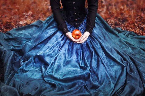 Snow White princess with the famous red apple. Girl holds stock photo
