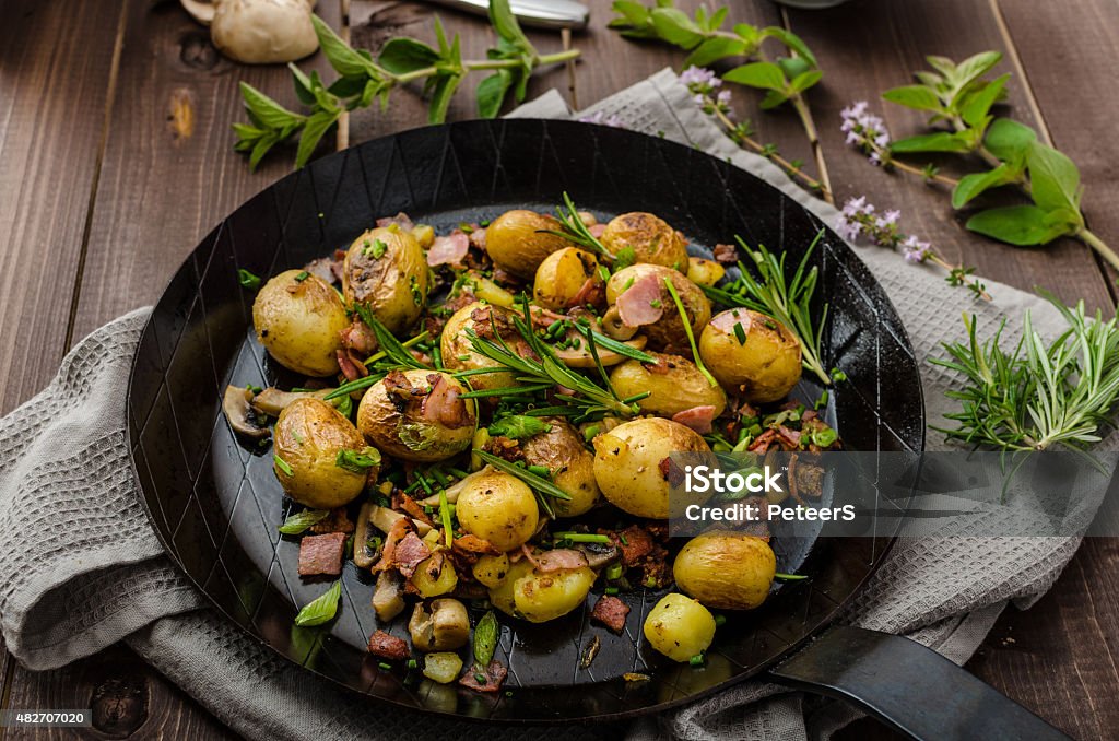 Cowboy potatoes with bacon and herbs Sauteed new potatoes with bacon and herbs 2015 Stock Photo