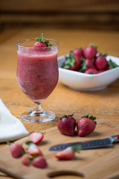 Panoramic still life of colorful frozen fruit granita drinks flowing in plastic takeaway cups with ice cream straws taste