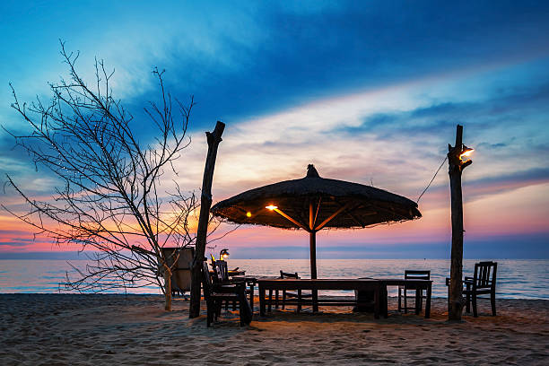istock Wooden chairs and umbrella on sand beach 482707516