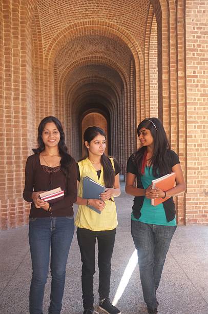 Three college students gossiping in the college alley.