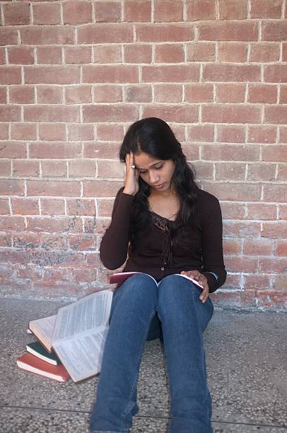 istock Tense Indian college student sitting with books. 482709371