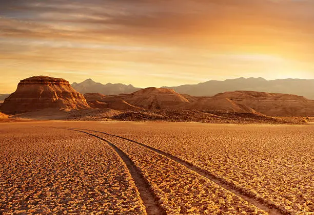 panoramic view death valley with some mountains on the back during sunset