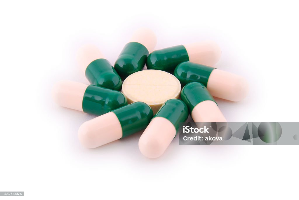 Pills from bottle on the white Pills from bottle on the white. Shallow depth 2015 Stock Photo