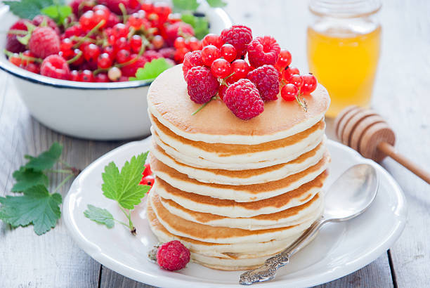 istock Pancakes with red berries and honey 482710384
