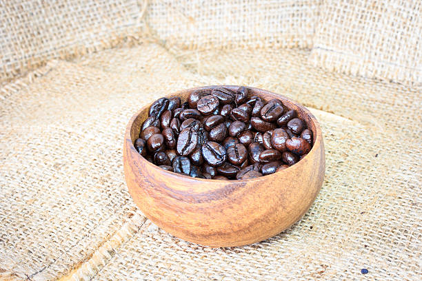 istock Cup full of coffee beans on the cloth sack 482710394