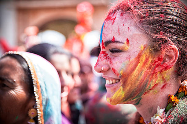 Happy young woman celebrating Holi in India. stock photo