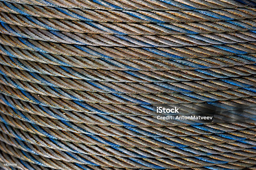 Steel rope Steel rope coil, iron cable, wire of grey, blue and gold colors, hawser abstract texture, industrial background  2015 Stock Photo