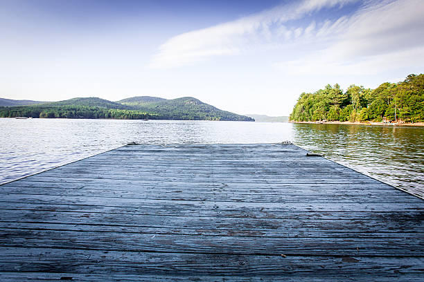Looking out on the lake from a dock Looking out on Lake Sacandaga from a local dock bollard pier water lake stock pictures, royalty-free photos & images