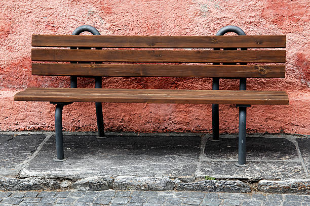 istock lonely bench in front of a pastle wall 482715466