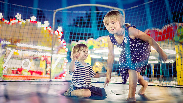 istock Little Boy  and girl  Jumping  on Trampoline 482723132