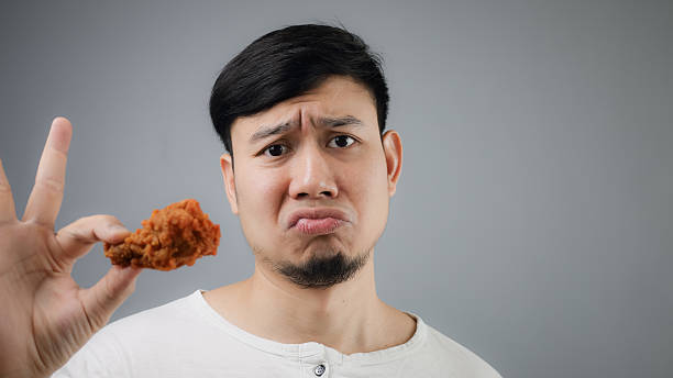 istock An Asian man with fried chicken. 482723496