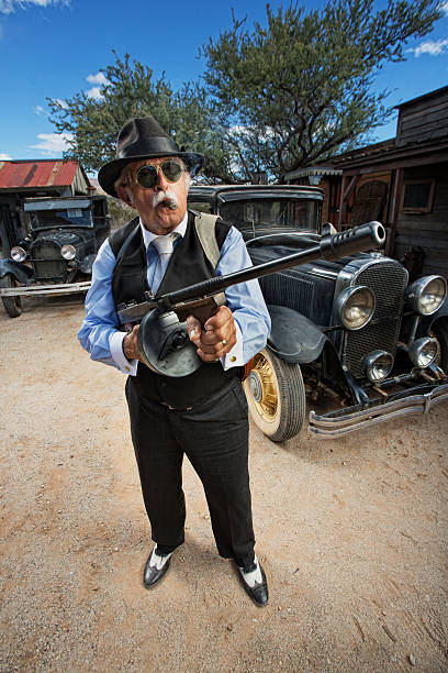 istock Gangster with Machine Gun Outdoors 482723619