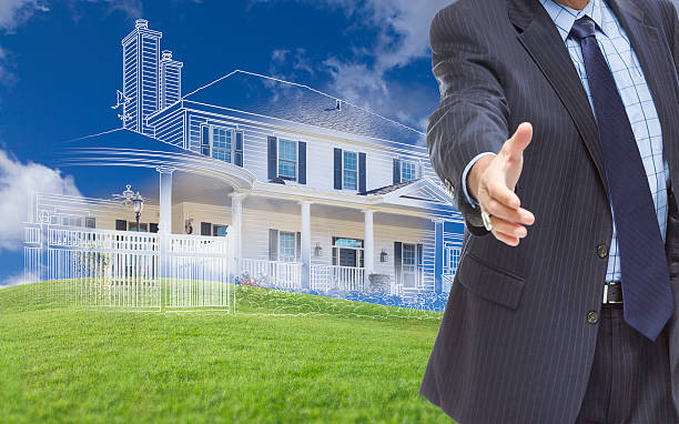 istock Male Hand Reaching for Handshake with Ghosted House Drawing Behi 482724182