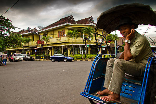 smiling rickshaw driver of malang, indonesia - malang stockfoto's en -beelden