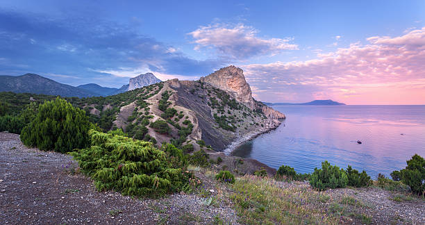 istock Beautiful summer sunset at the sea with mountains, trees 482725514