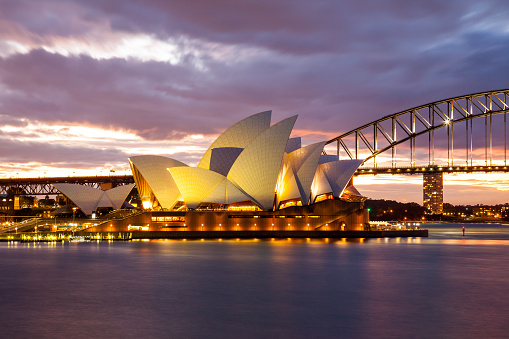 Sydney, Australia - July 11, 2010; Sydney Opera House and the Harbour Bridge at dusk. Taken from Mrs. Macquarie's Point.
