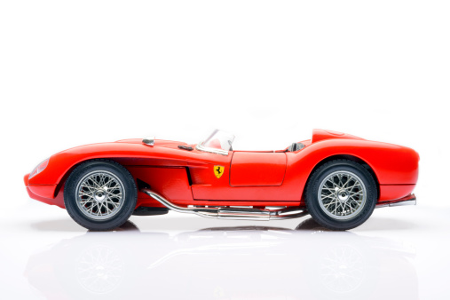 Kampen, The Netherlands - March 26, 2014: 1957 Ferrari 250 Testa Rossa classic race car model by Bburago isolated on a white background.