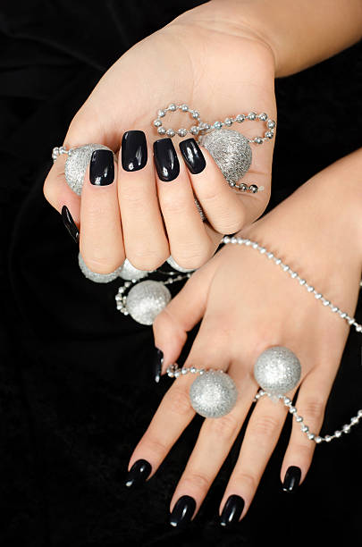 istock Close up on beautiful female hand with black manicure. 482726963