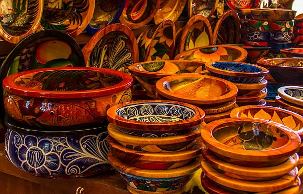 Handcrafted pottery with traditional Mexican patterns and designs for sale at a Mexican flea market in Puerto Vallarta.
