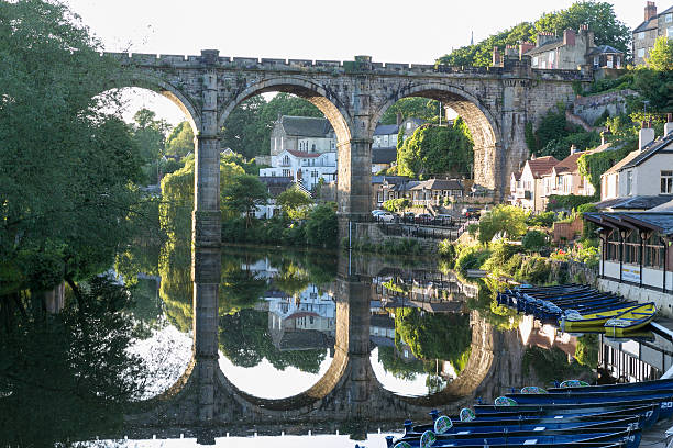 Knaresborough, England - June 07, 2014: A classic view from the castle of the market town of Knaresborough in North Yorkshire, England. Shows the river Nidd and train on the railway viaduct with houses and architecture of the town centre.