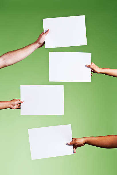 istock Hands hold four blank signs, ready for your message 482730491