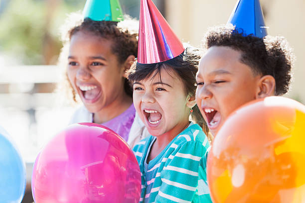 istock Multi-ethnic children at birthday party laughing and shouting 482731696