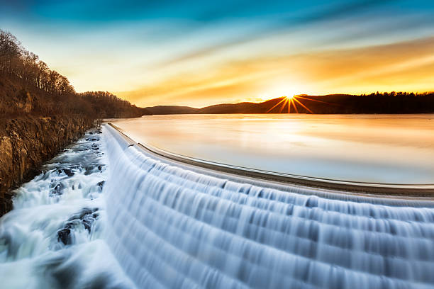 Sunrise over Croton Dam, NY Sunrise over Croton Dam, NY and its stepped spillway waterfall. A very long exposure and the natural motion blur creates an artistic smooth and silky effect on the falling water. reservoir photos stock pictures, royalty-free photos & images