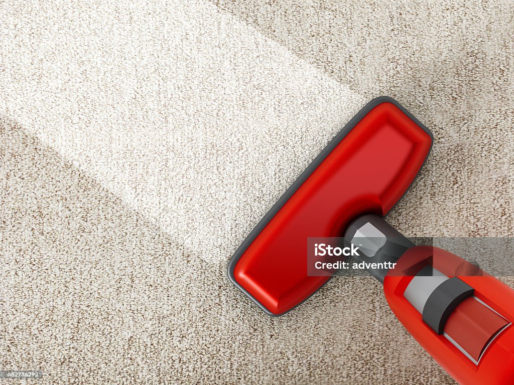 Vacuum cleaner Red vacuum cleaner cleaning a carpet. Carpet - Decor Stock Photo