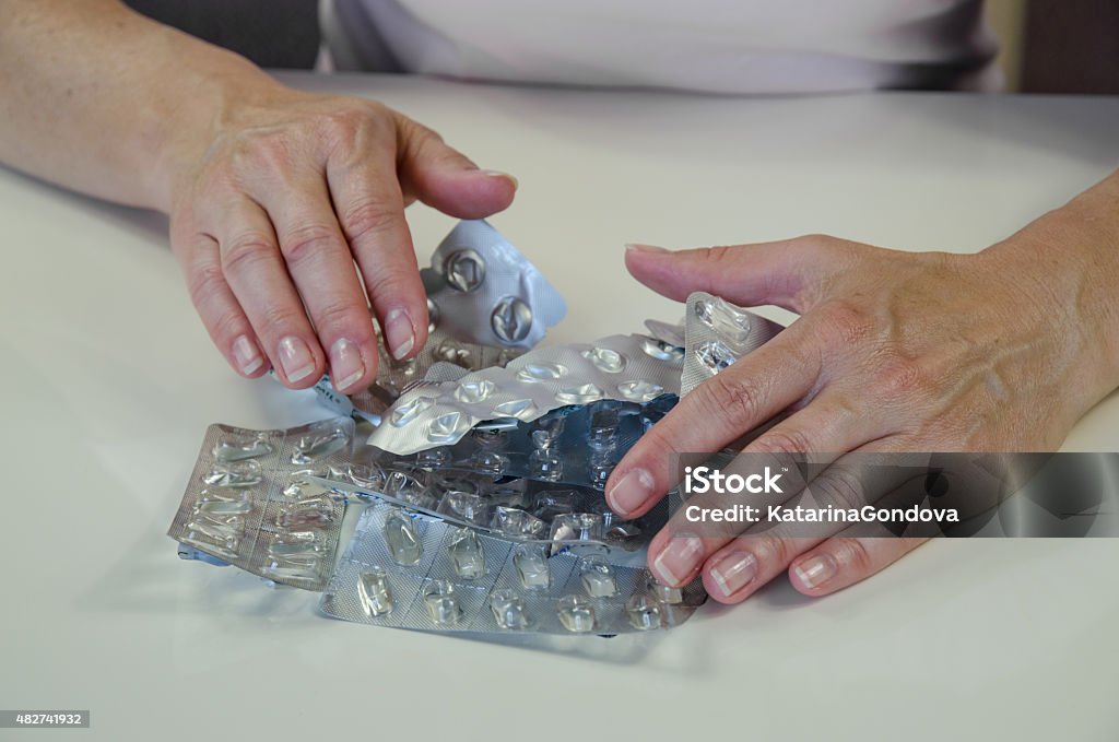 hand with empty blisters of pills human hand holding empty blisters from medicals 2015 Stock Photo