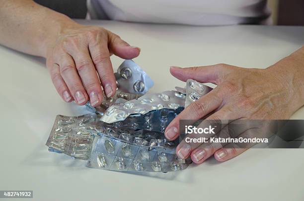 Hand With Empty Blisters Of Pills Stock Photo - Download Image Now - 2015, Blister, Concepts