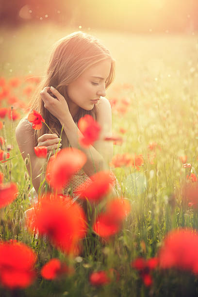 istock young woman picking poppies 482743503