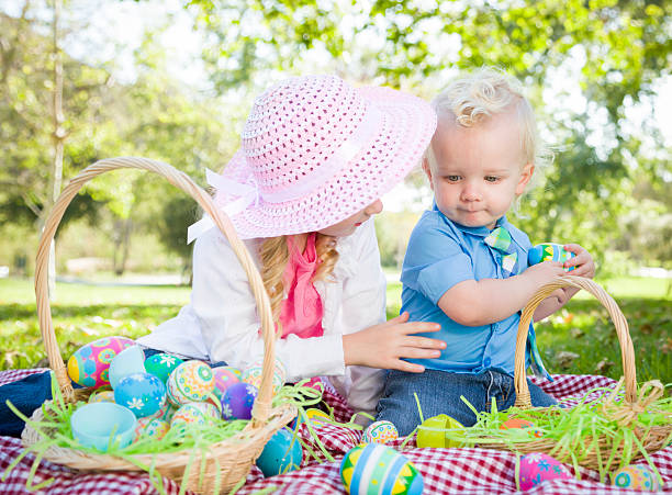 istock Cute Young Brother and Sister Enjoying Their Easter Eggs Outside 482744881