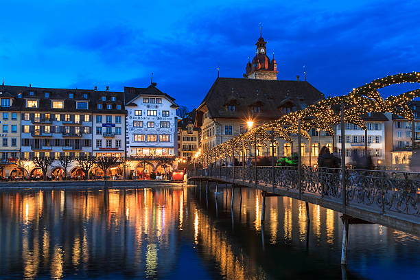Lucerne at Christmas, Switzerland Lucerne, Switzerland - December 13, 2014: People crossing the Rathaussteg over the Reuss River in Lucerne. The city is decorated with lights for Christmas. lucerne switzerland stock pictures, royalty-free photos & images