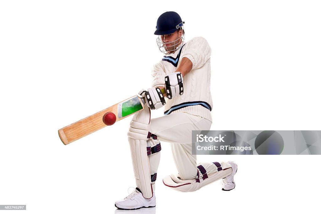 Cricketer playing a shot Cricketer down on his knee playing a shot, studio shot on white background. Cricket Player Stock Photo