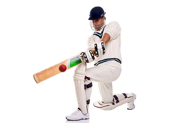 Cricketer playing a shot Cricketer down on his knee playing a shot, studio shot on white background. cricket player stock pictures, royalty-free photos & images
