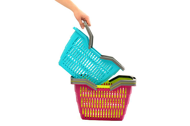 Woman hand taking a shopping basket from the pile. stock photo