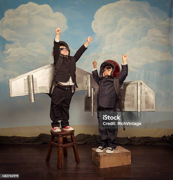 Two Business Boys Wearing Jetpacks Fly High Stock Photo - Download Image Now - Child, Innovation, Boys