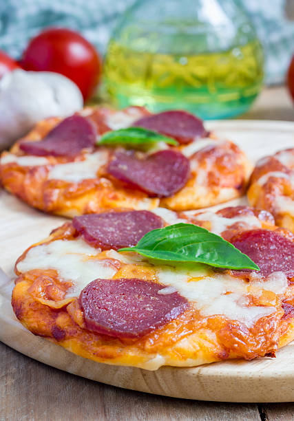 istock Homemade mini pepperoni pizza on a wooden board 482746790