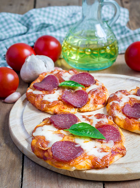 istock Homemade mini pepperoni pizza on a wooden board 482746800