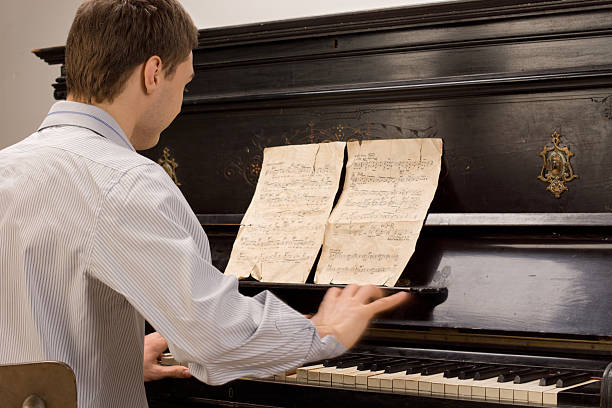 Young pianist sitting practicing at the piano
