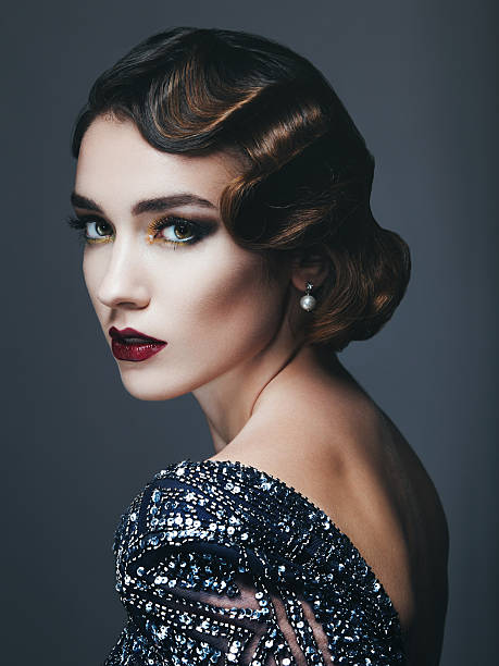 Glam retro diva Studio portrait of beautiful glamourous  woman wearing shiny dress. 20's - 30's styled image. Professional make-up and hairstyle. High-end retouch. actress headshot stock pictures, royalty-free photos & images