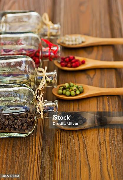 Glass Bottles With Fourcolor Peppers Stock Photo - Download Image Now - At The Edge Of, Black Color, Bottle