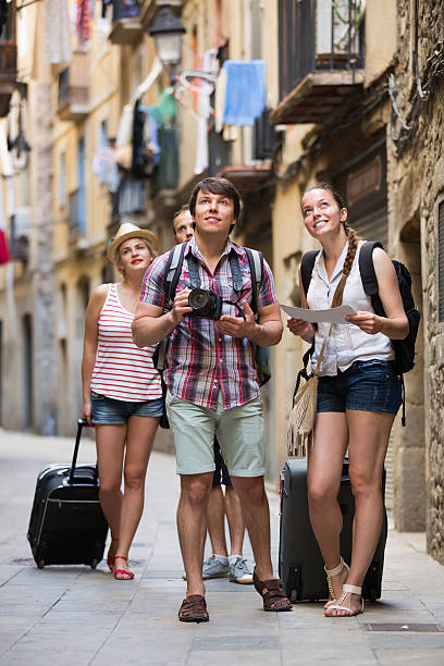 istock Group of merry tourists with camera and map 482748576