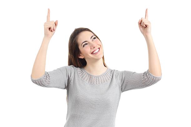 istock Happy woman pointing up with both hands 482748709