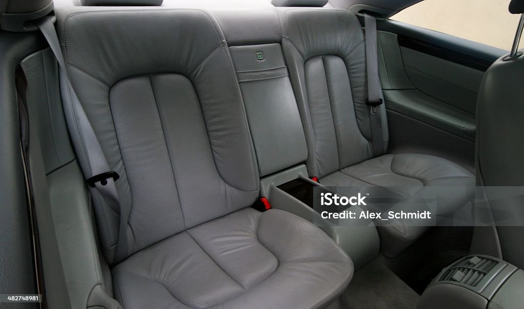 Rear gray leather vehicle seats A close-up photo of Rear gray leather vehicle seats Armrest Stock Photo