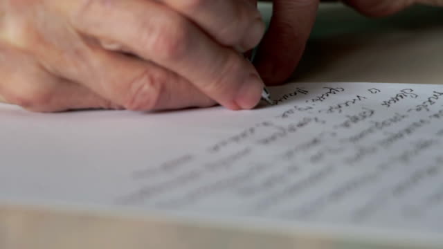 hand of old woman writing letter