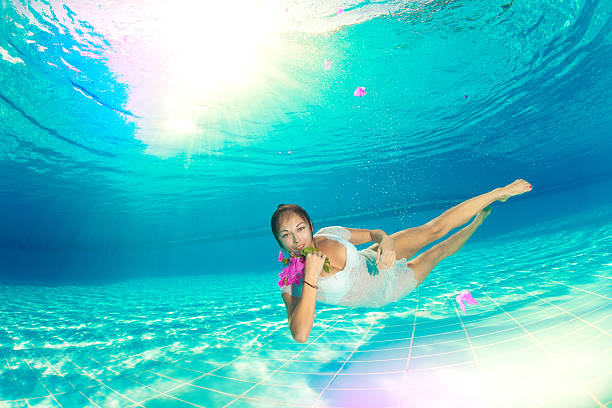 istock underwater swimming with flowers 482749965