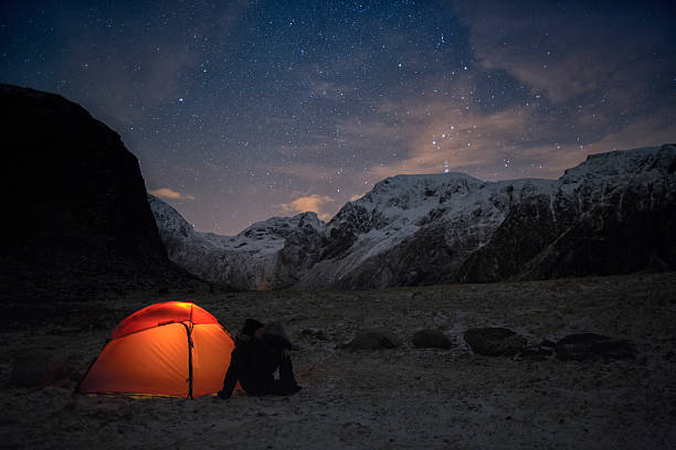 istock Lonely camper looking at the starry sky in wintertime 482750223