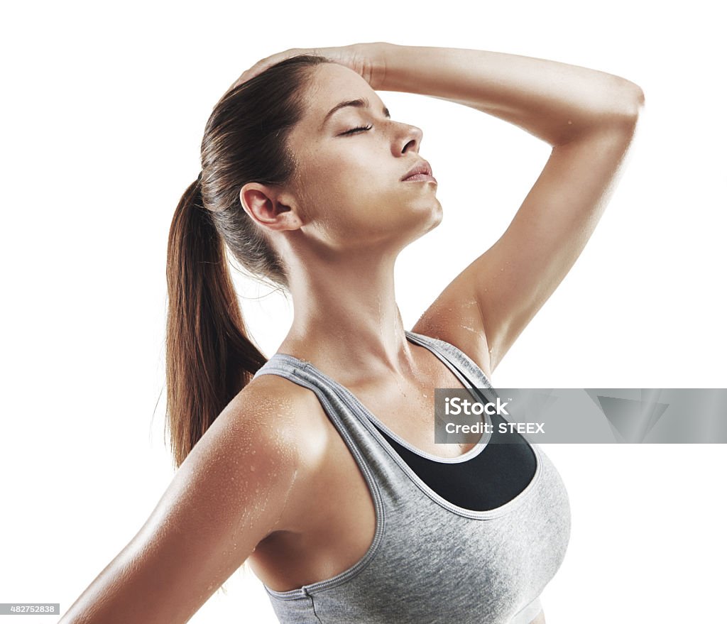 Feeling refreshed after her workout Cropped shot of a young female athlete against white backgroundhttp://195.154.178.81/DATA/i_collage/pu/shoots/805377.jpg 20-29 Years Stock Photo